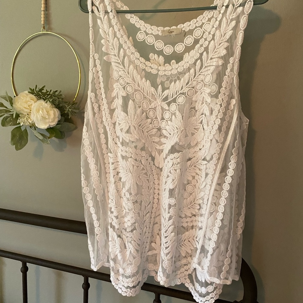 Sheer, lacy sleeveless blouse.